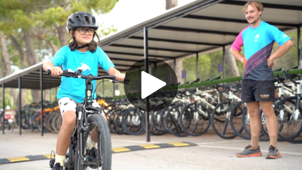 Young girl cycling with a Neilson expert guiding her