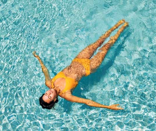 woman floating in a swimming pool