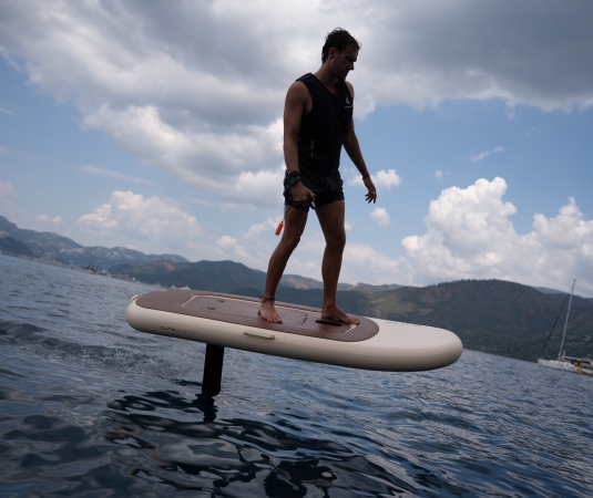 A man efoiling in a calm bay
