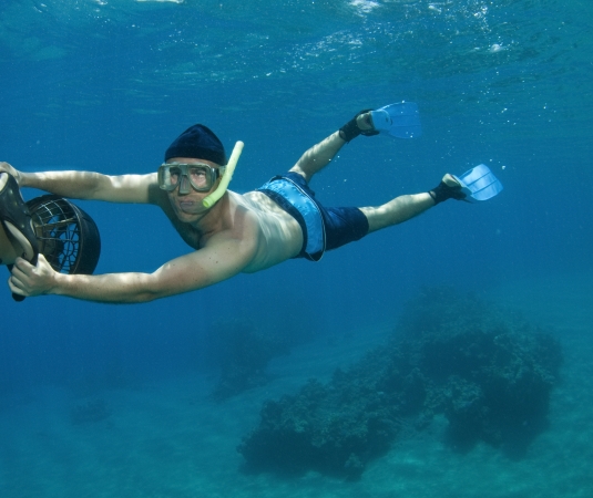 A man using a sea scooter underwater