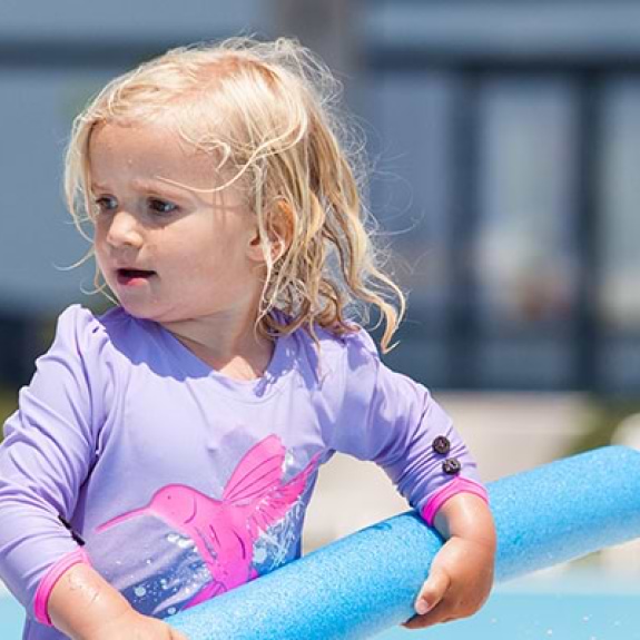 toddler playing in swimming pool