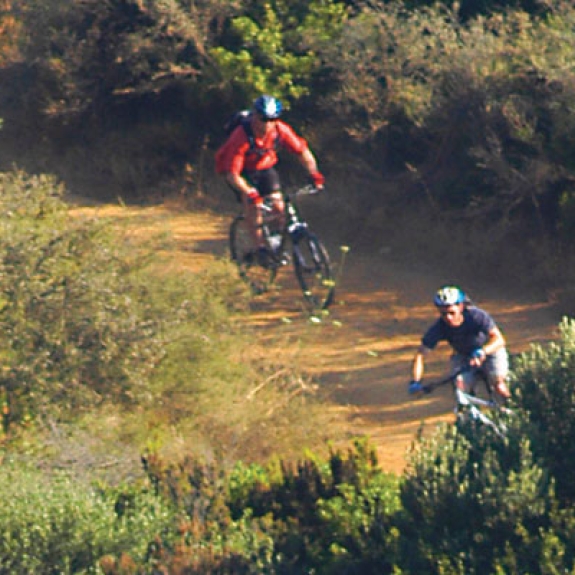 Two people mountain biking in countryside of Lefkada, Greece