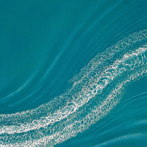 Aerial image of wakeboarder and speed boat