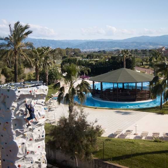 climbing wall with swimming pool in background