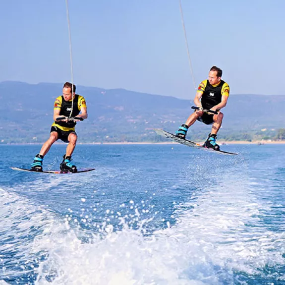 Jumping the boat wake on a wakeboard
