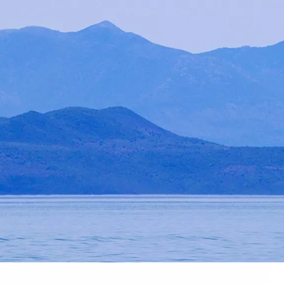 dinghy sailing in a bay in Greece