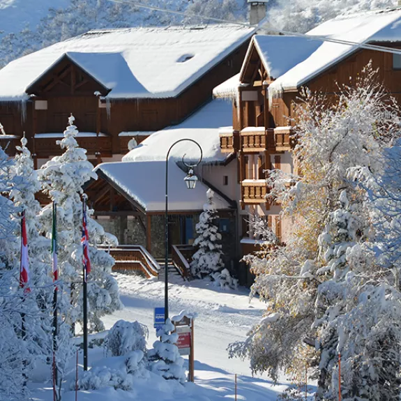 View of a snow covered Neilson Mountain Collection hotel