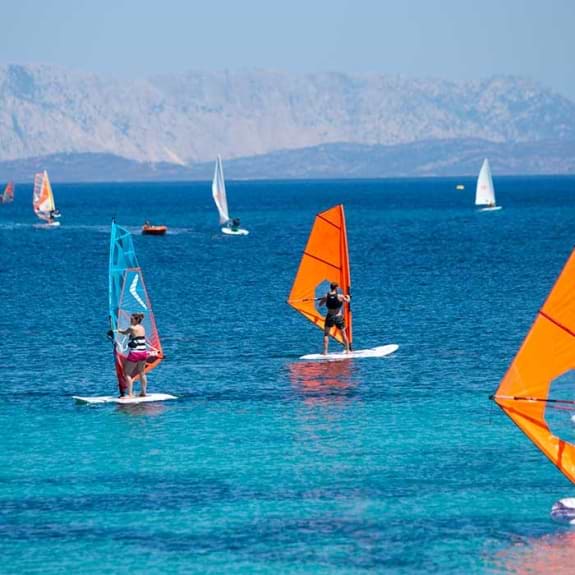 Group of beginners windsurfing