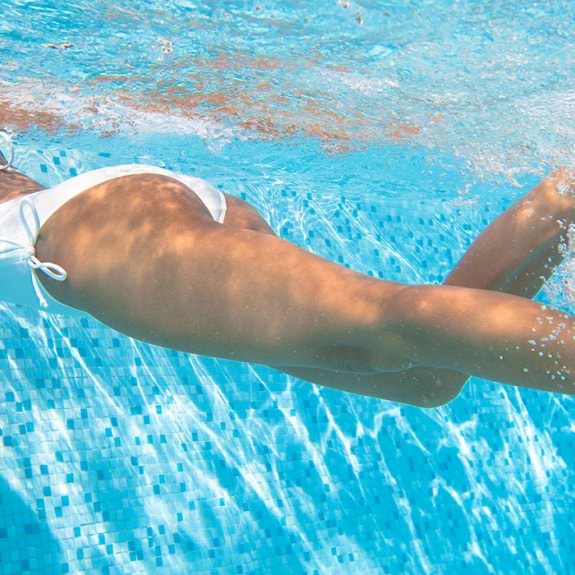 woman swimming under water