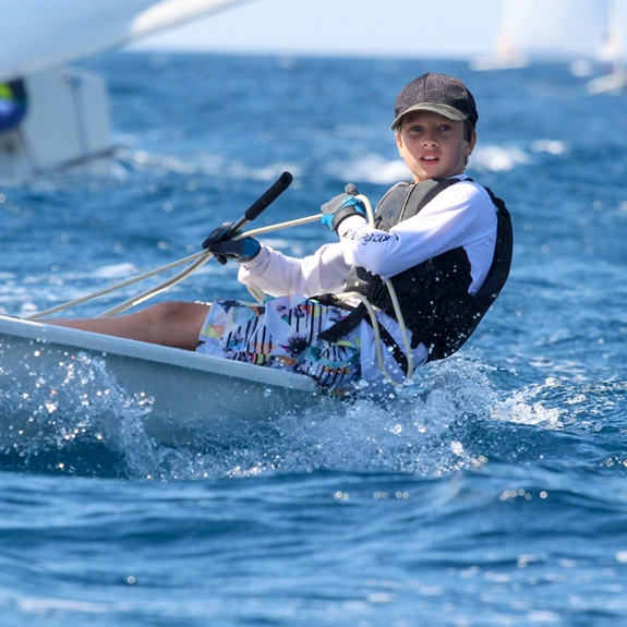 young boy dinghy sailing