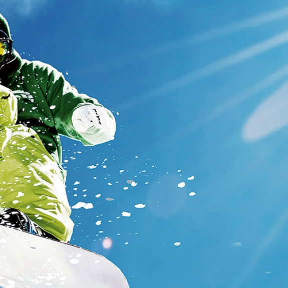 snowboarder jumping in powder snow