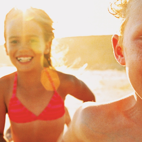 4 children running on a beach
