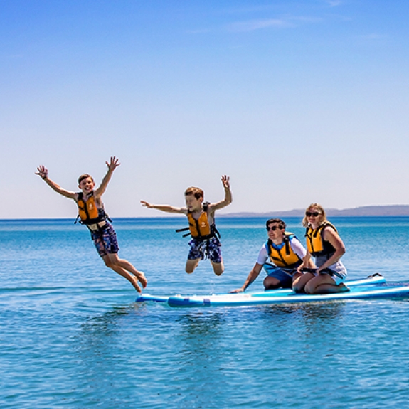 little girl sitting on dads shoulders