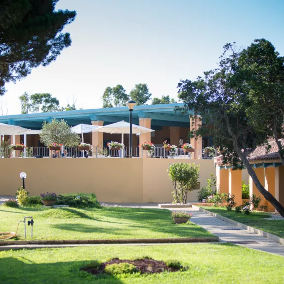 Restaurant terrace and room exteriors at Baia dei Mori Beach Club