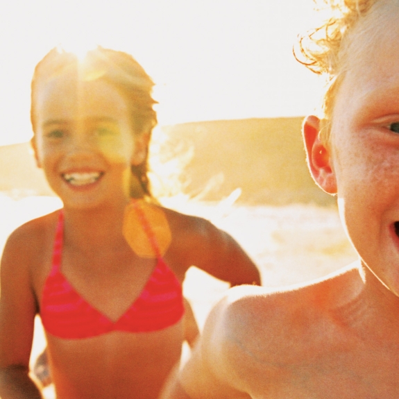 Kids running on a beach