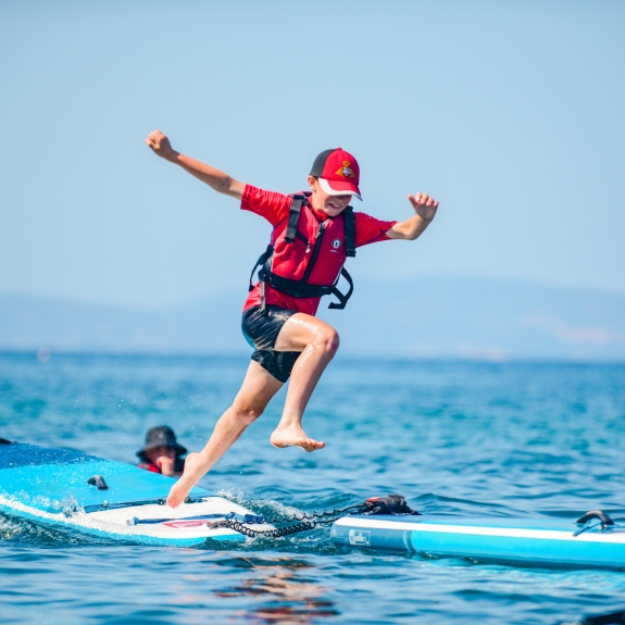 Kids' club enjoying the paddle boards at Vounaki Beach Club