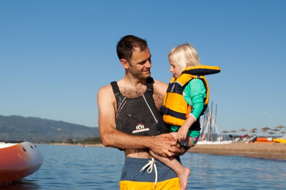 Man and young girl in sea