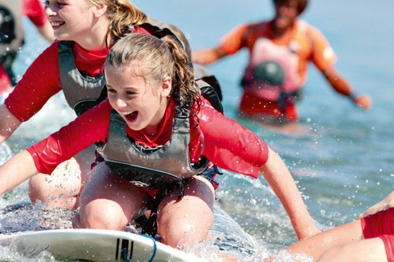Group of children playing and splashing in sea
