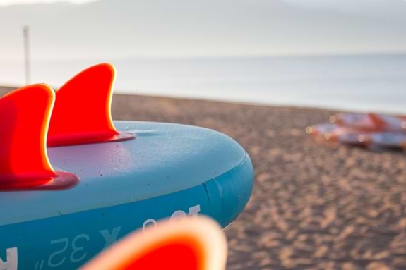 stand up paddle boards and kayaks on a beach in Greece