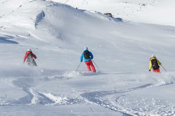 Group of people skiing in powder