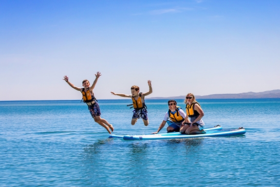 little girl sitting on dads shoulders