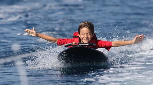 Young boy on kneeboard