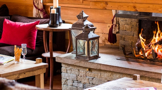 lounge and open fire in a Neilson ski chalet