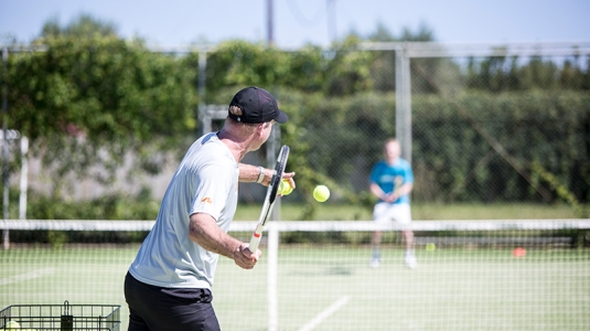 two people playing tennis