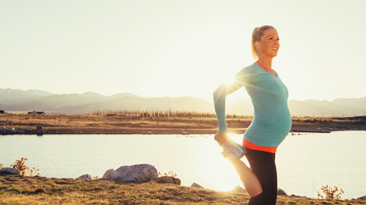 Pregnant woman stretching after a run