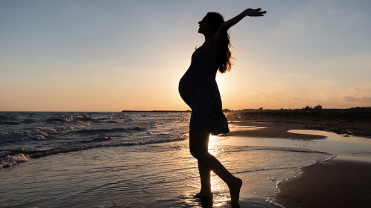 Pregnant woman on beach