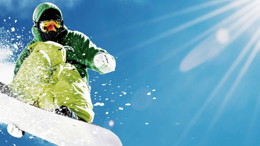 snowboarder jumping in powder snow