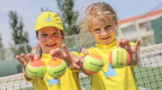Girls holding tennis balls