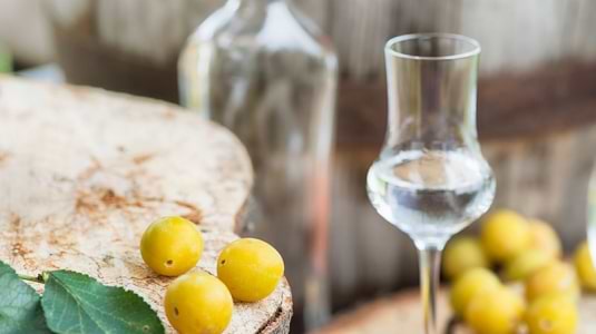 Fruits next to a glass