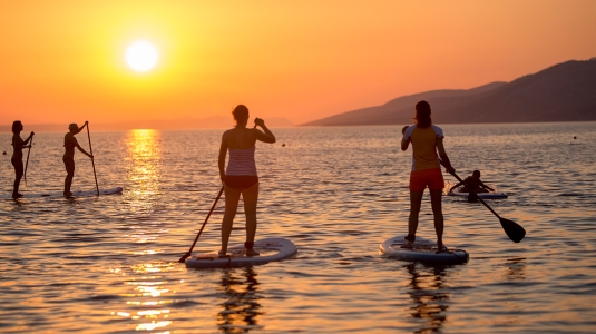 sunset stand up paddle boarding