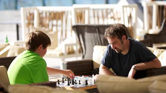 Father and son playing chess