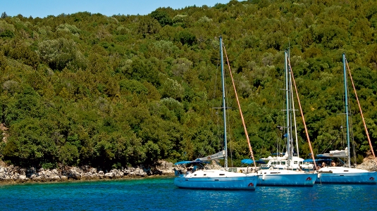 three yachts moored up in a bay