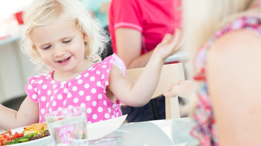 young girl easting dinner