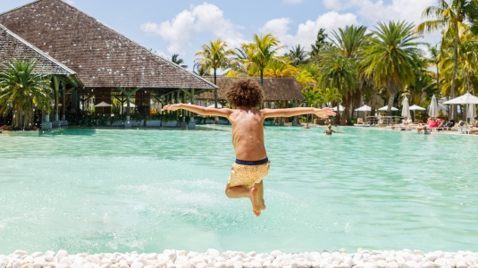 Kid jumping into pool Mauritius
