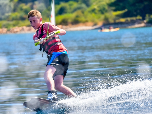 young boy wakeboarding