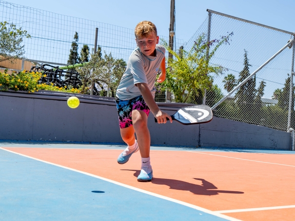 boy playing pickleball