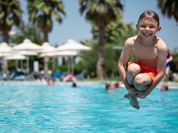 boy jumpingin pool