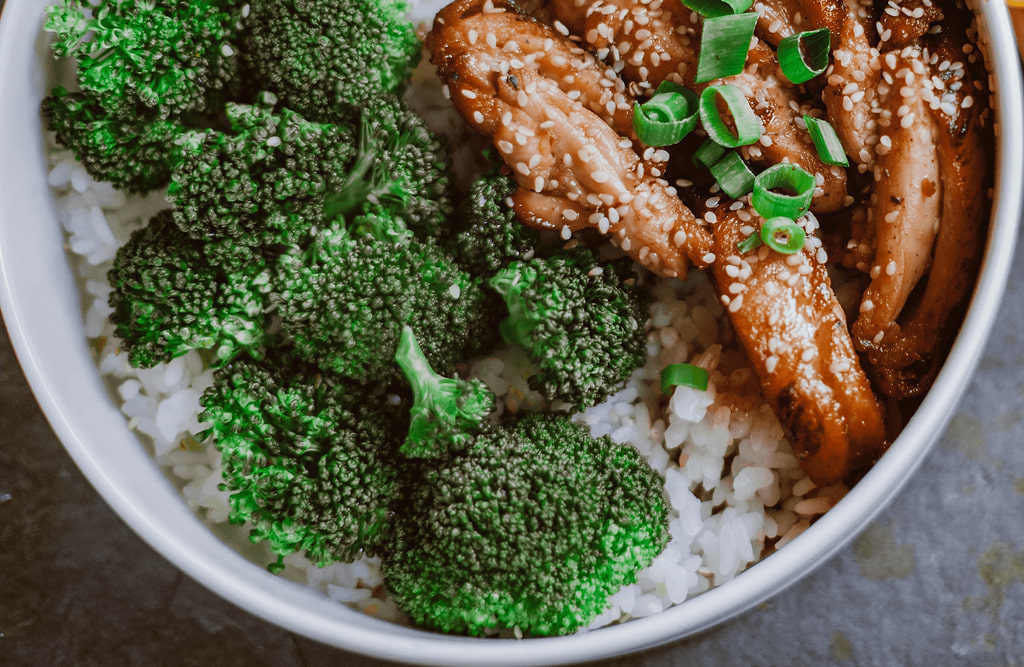 Brown rice bowl with grilled salmon, broccoli, and edamame