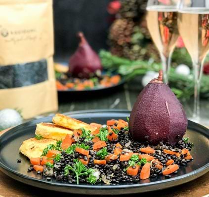 Peer met wijn, geroosterde koolraap en zwarte linzensaladeimage