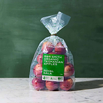 Clear compostable packaging filled with apples