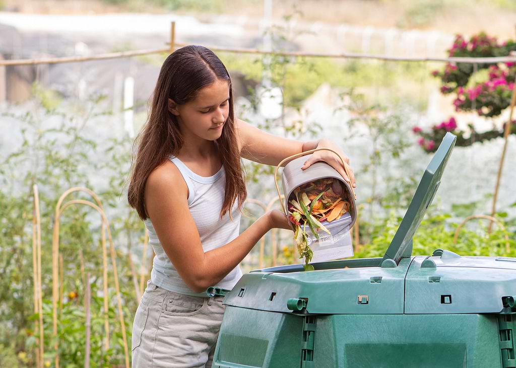 Putting compost into a compost bin