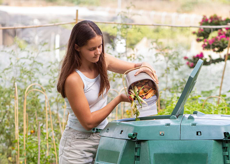 Putting compost into a compost bin