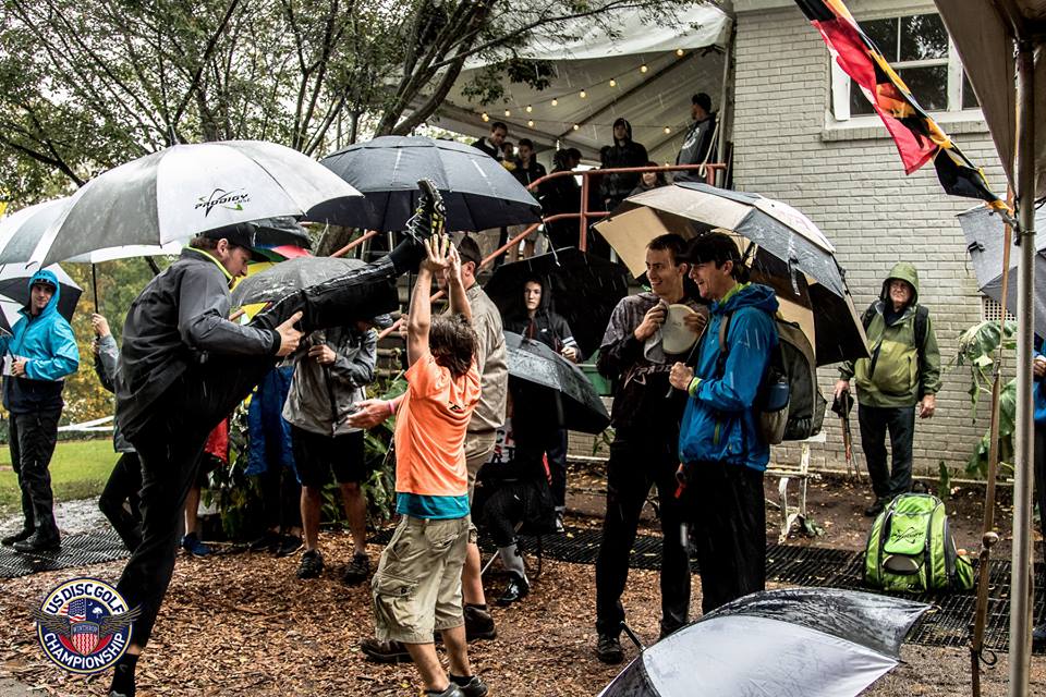 Players and fans with umbrellas in tow preparing the final round in 2015