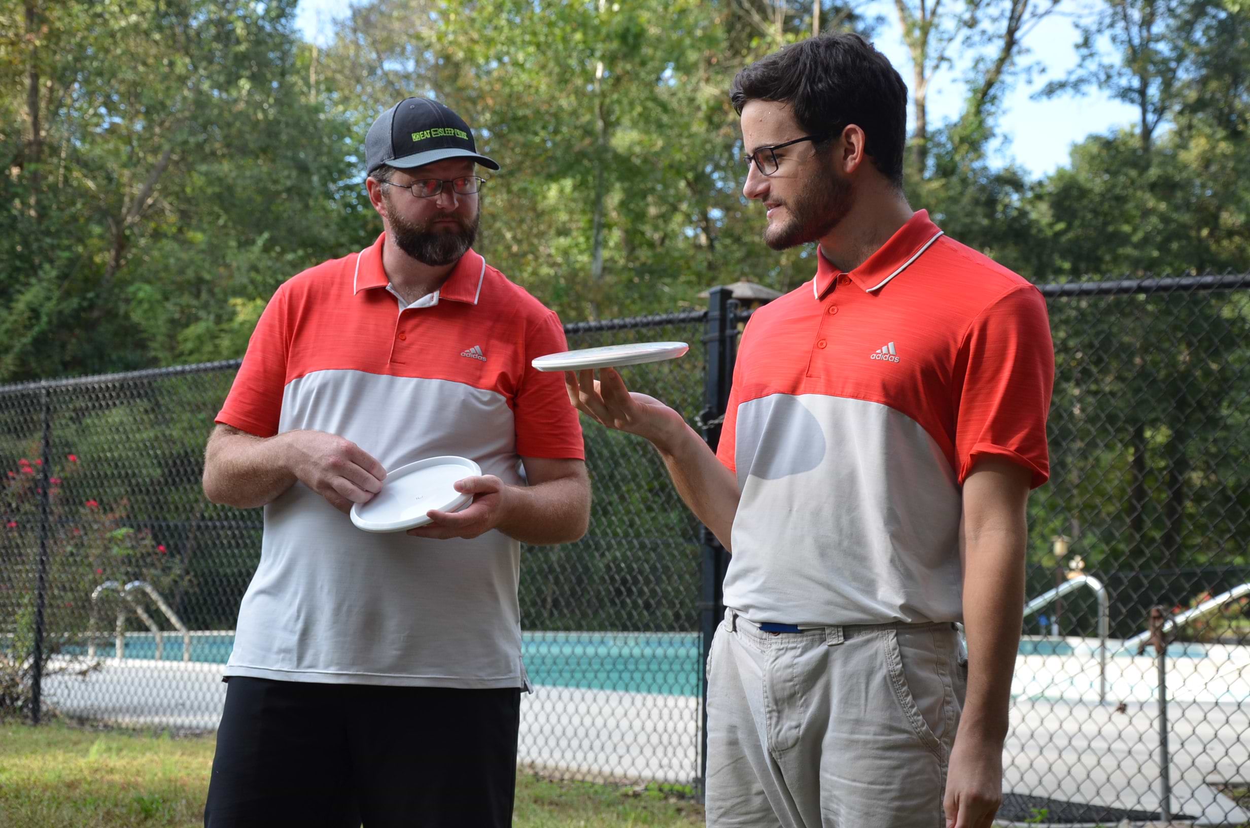 James Hopkins (left) and Aaron Shindledecker get to know their trophy discs after winning USDGC Doubles for the second time in a row.