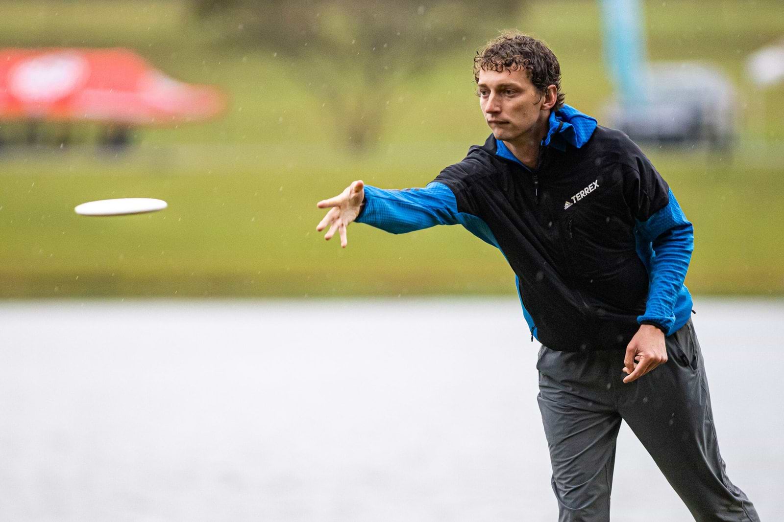 Calvin Heimburg throws a disc beside the lake during Saturday’s rainy USDGC round.