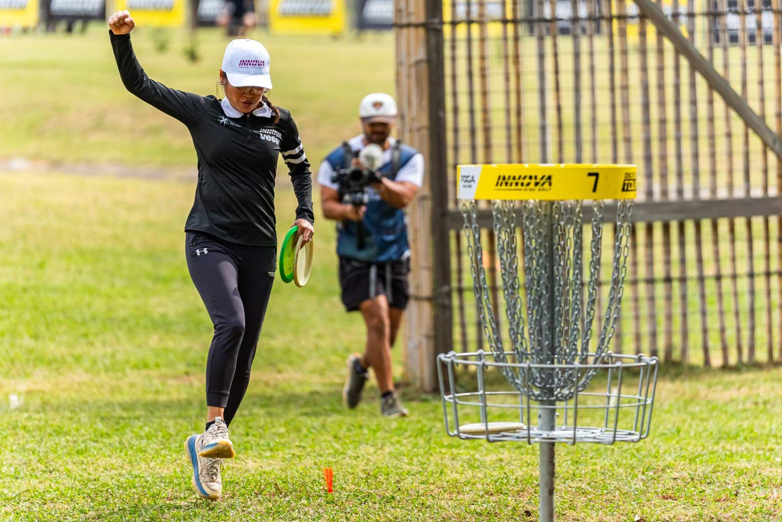 Ohn Scoggins raises her fist beside the seventh basket during Friday’s Throw Pink round.